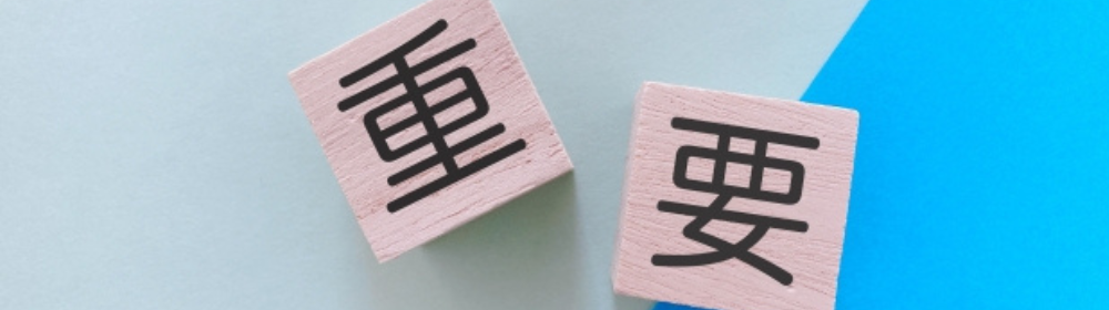 木目背景と緑の装飾の中に置かれた「まとめ」の文字ブロック